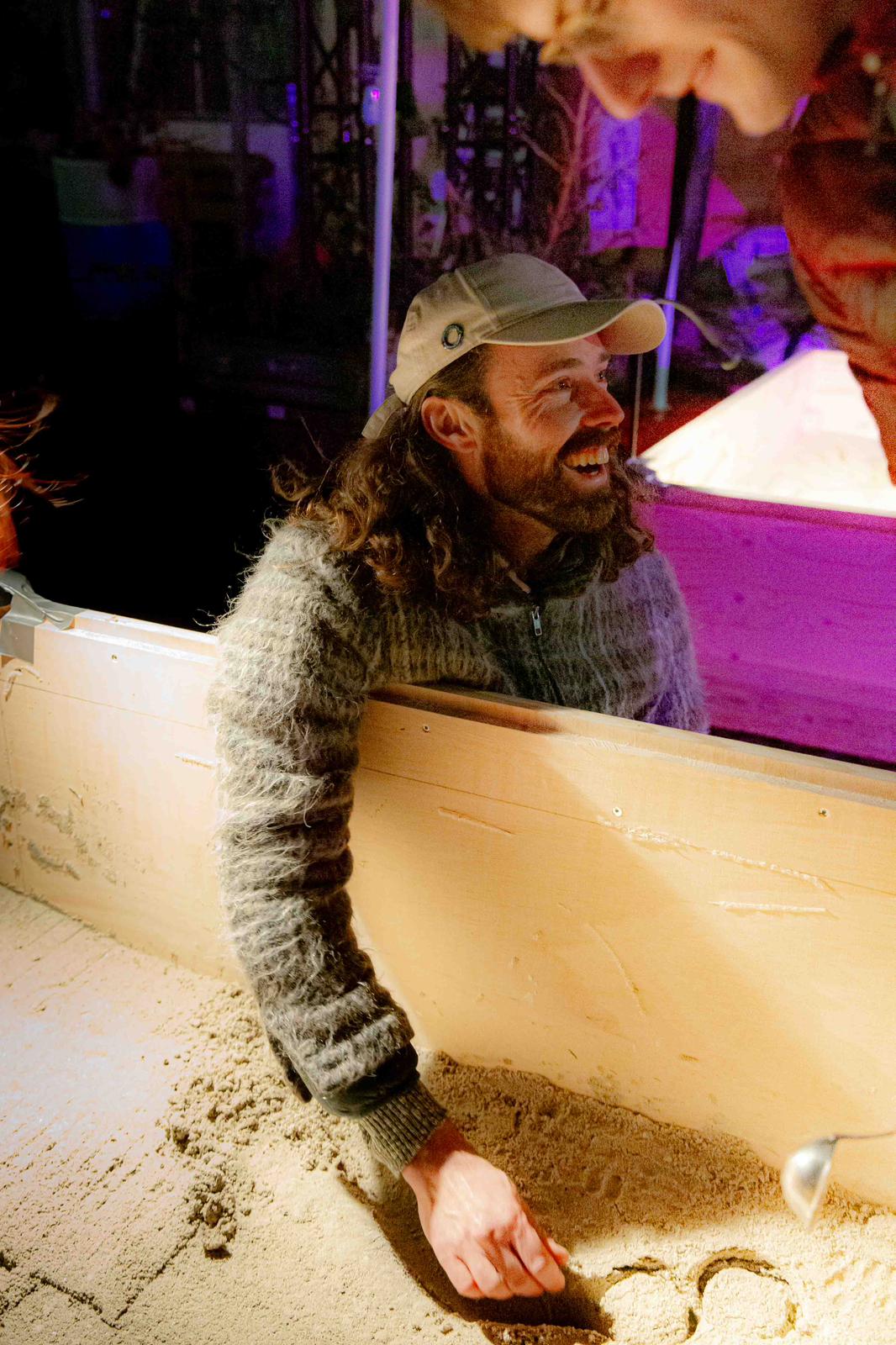 Casting event — participant shaping sand mould